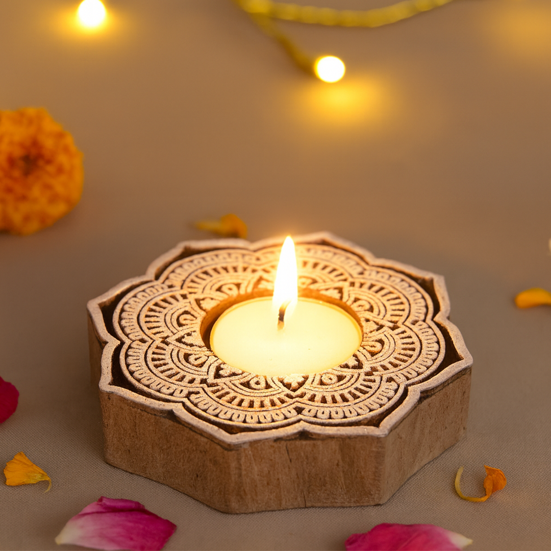 Decorative wooden tealight holder with a lit candle on a neutral background with flowers and lights.