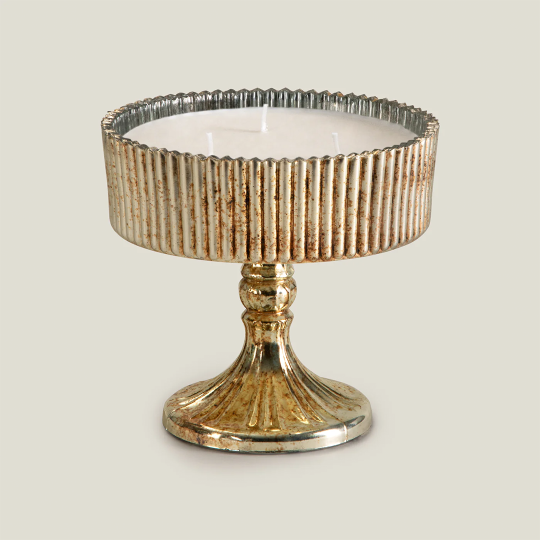 Decorative candle holder with ribbed design on a beige background
